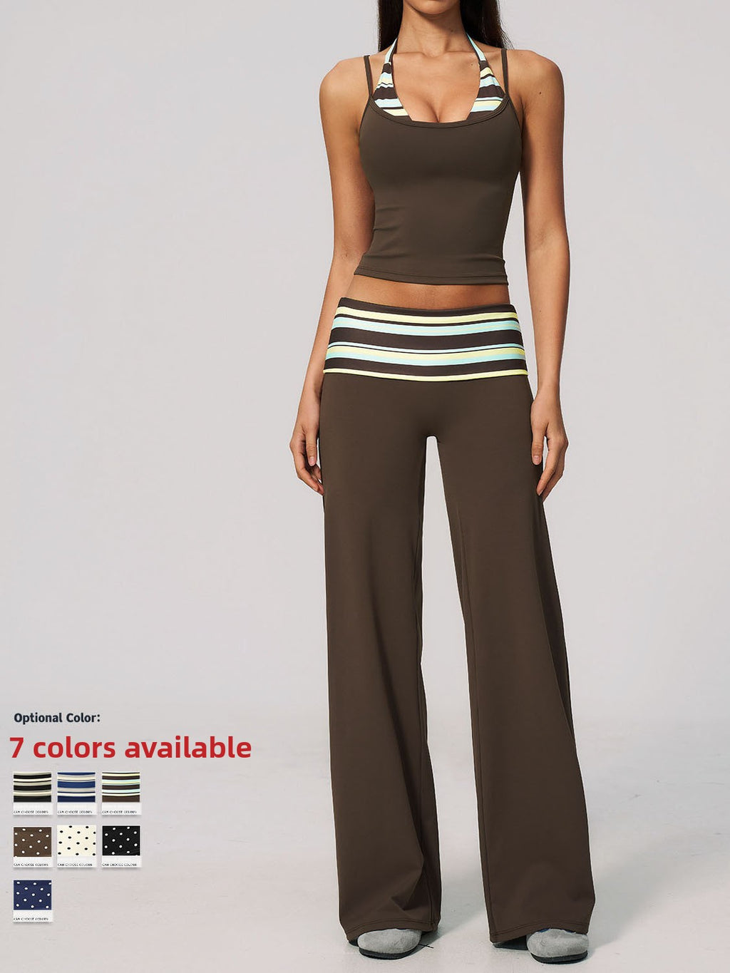 A woman modeling a matching two-piece activewear set consisting of a brown halter crop top and wide-leg pants, both featuring a striped waistband detail. The image is set against a plain light gray studio background with a text overlay in the bottom left indicating 'Optional Color: 7 colors available' alongside color swatches.